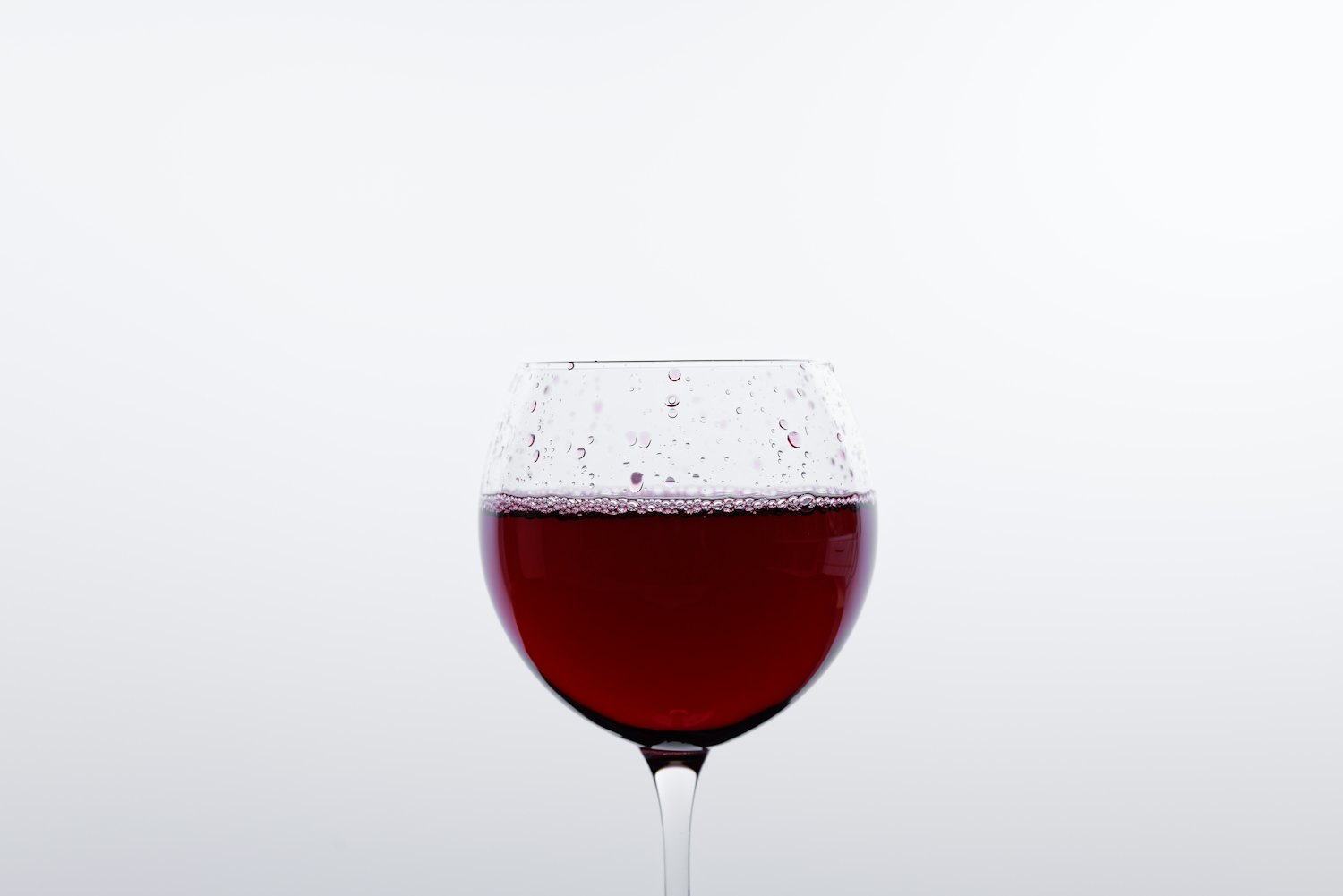 A glass of deep red Bonarda