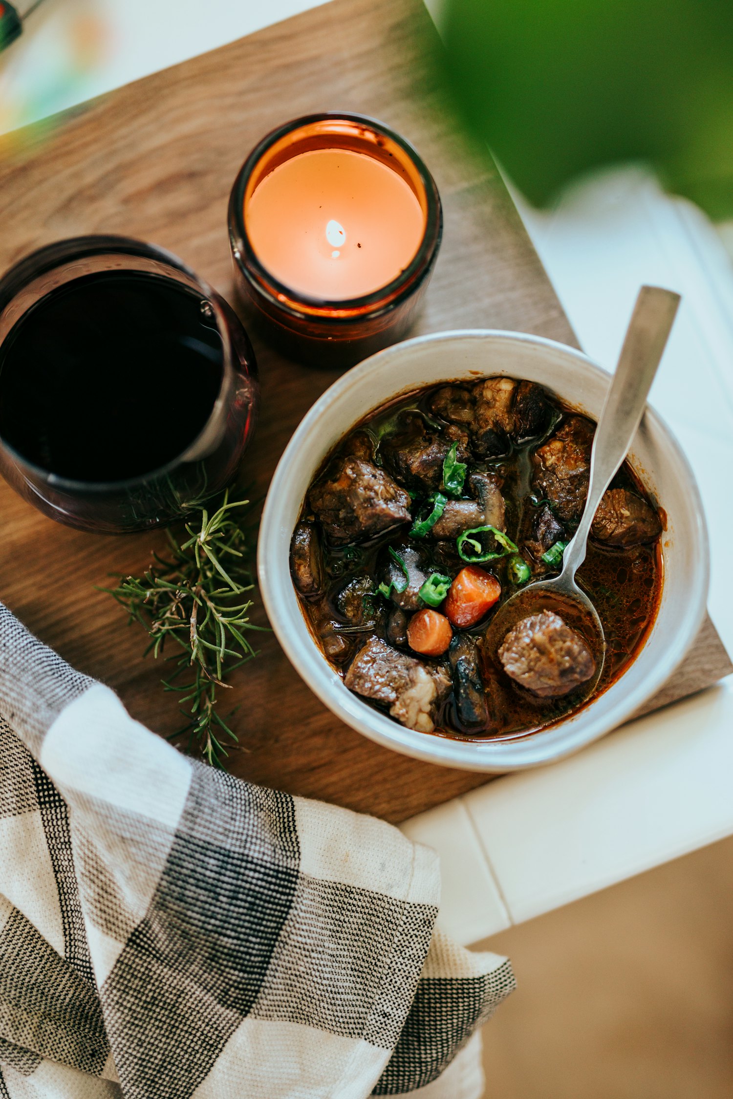 A bowl of thick rustic stew with corn, beans and meat