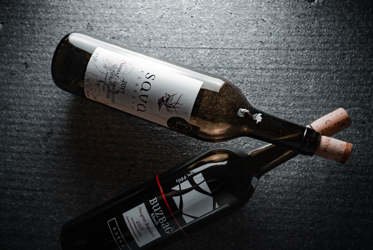 A wine bottle on a dark table in soft warm light