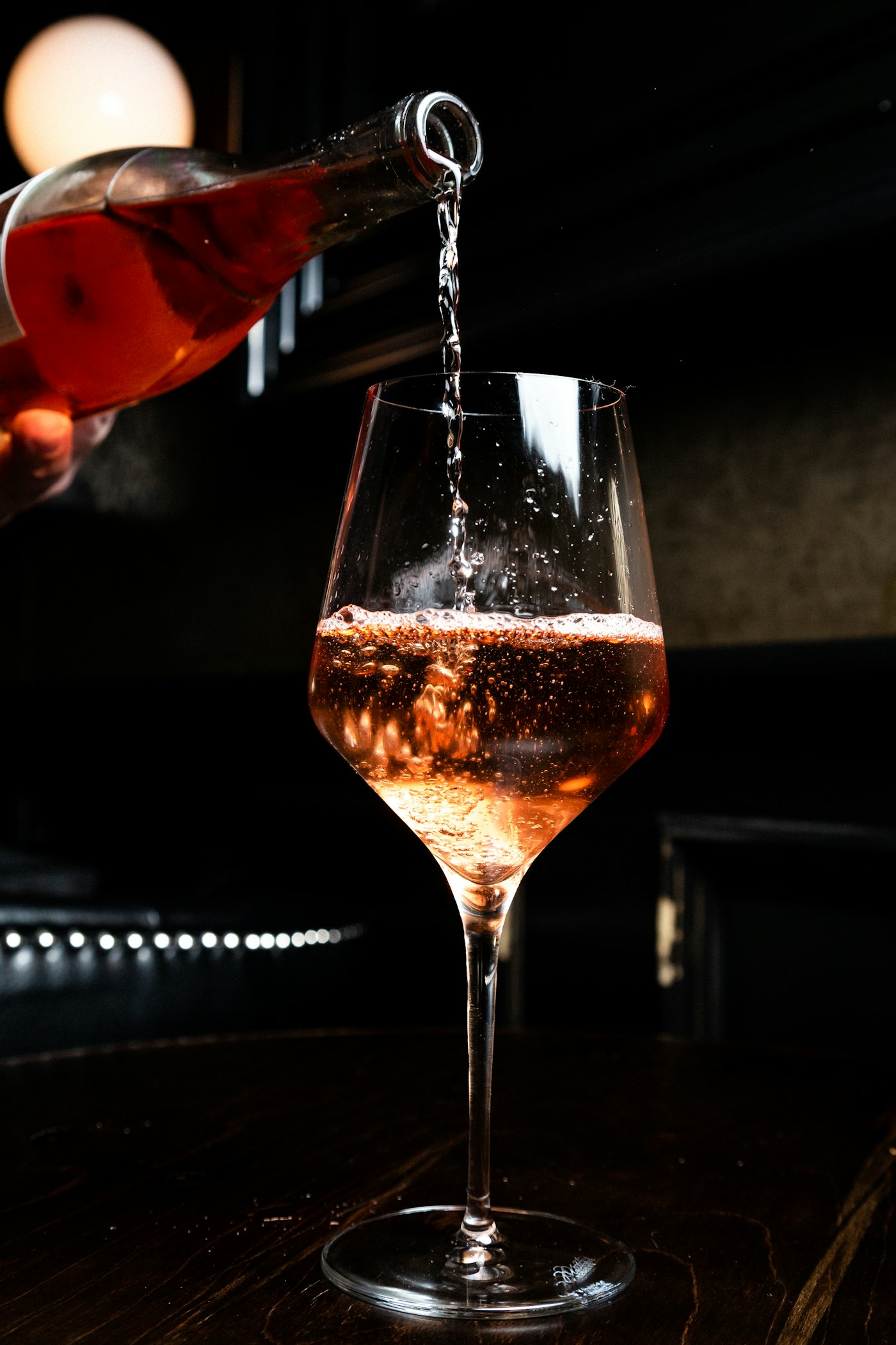 A tall sparkling-wine glass in warm light, showing the slim profile of a flute